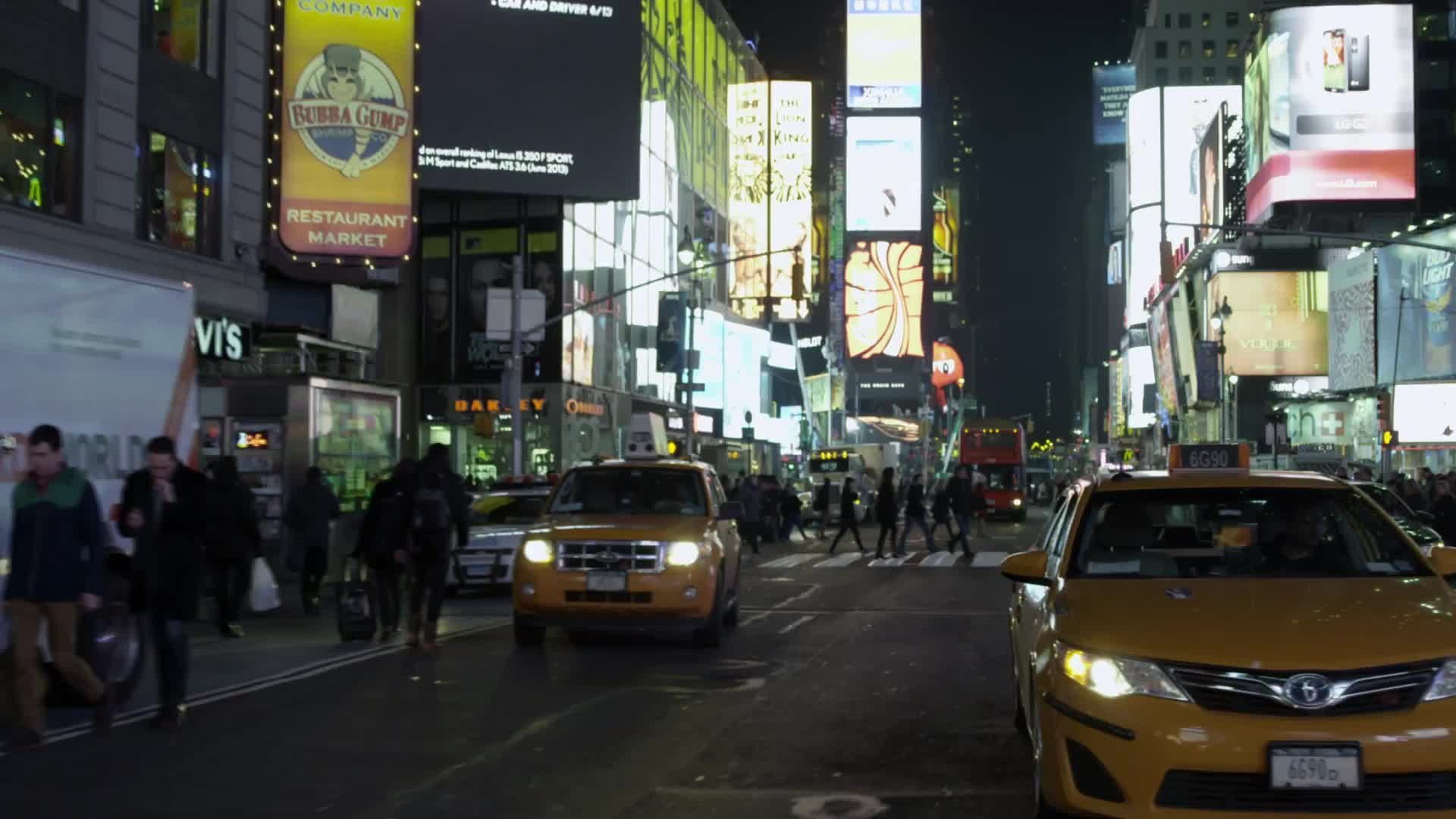 Times Square taxicab driving in slow motion at night in NYC