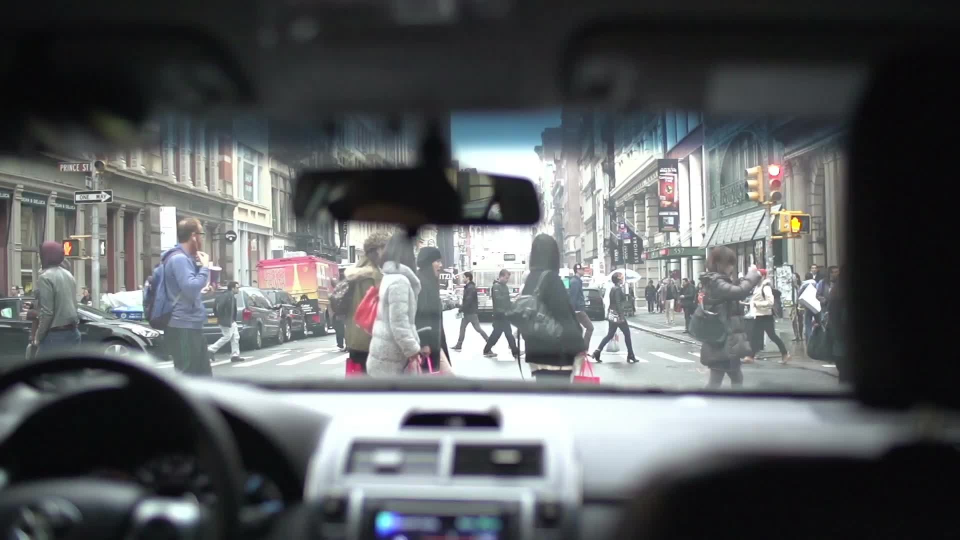 people crossing street - crosswalk from driver pov in super slow motion in NYC on winter day