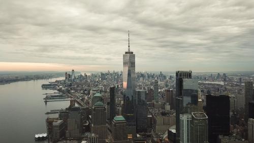 Freedom Tower aerial on cloudy day - Manhattan buildings and skyscrapers in New York City NYC