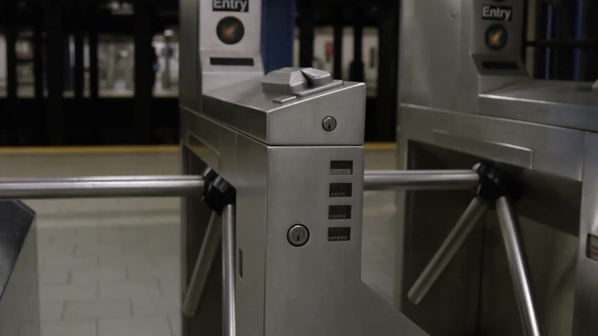 tracking shot of turnstiles in empty subway station in NYC